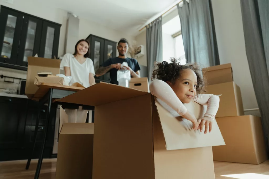 Picture of a girl sitting inside a box during cleaning