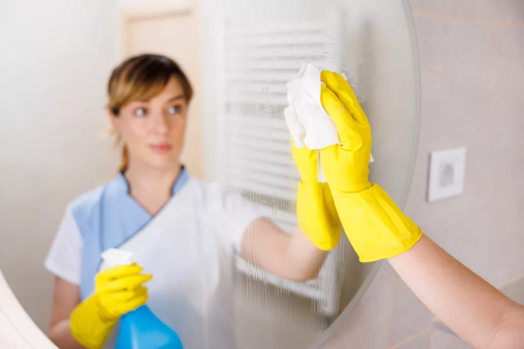 Picture of a woman cleaning the mirror