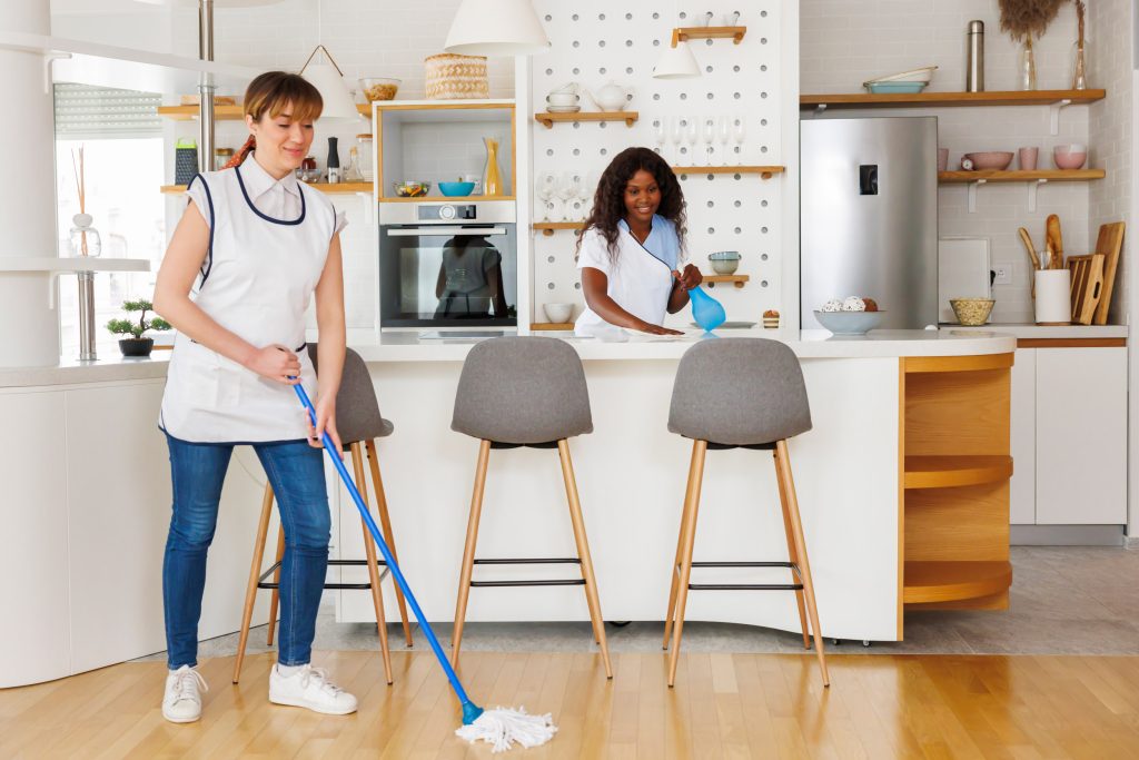 Female workers cleaning a room